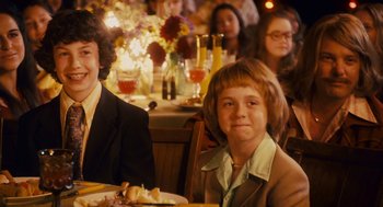 Movie still from “Grown Ups” (2010), directed by Dennis Dugan – A group of people sitting at a table with food; Medium shot, Over the shoulder angle