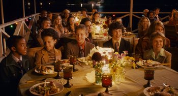 Movie still from “Grown Ups” (2010), directed by Dennis Dugan – A group of people sitting at a dinner table; Wide shot, High angle