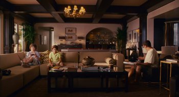 Movie still from “Grown Ups” (2010), directed by Dennis Dugan – A woman sitting on top of a couch in a living room; Wide shot, High angle