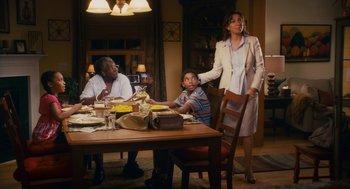 Movie still from “Grown Ups” (2010), directed by Dennis Dugan – A woman standing at a dining room table with two men and a boy; Medium shot, Over the shoulder angle