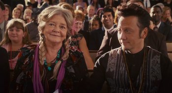 Movie still from “Grown Ups” (2010), directed by Dennis Dugan – A woman and a man sitting next to each other in a crowd; Close Up shot, Over the shoulder angle