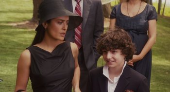 Movie still from “Grown Ups” (2010), directed by Dennis Dugan – A woman and a young boy in a suit and tie; Medium shot, Over the shoulder angle