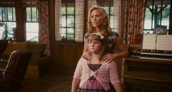 Movie still from “Grown Ups” (2010), directed by Dennis Dugan – A woman standing next to a young girl in front of a window; Medium shot, Over the shoulder angle