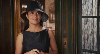Movie still from “Grown Ups” (2010), directed by Dennis Dugan – A woman wearing a black dress and a black hat; Close Up shot, Over the shoulder angle