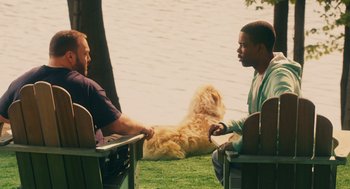 Movie still from “Grown Ups” (2010), directed by Dennis Dugan – Two men sitting in lawn chairs next to a body of water; Medium shot, Over the shoulder angle