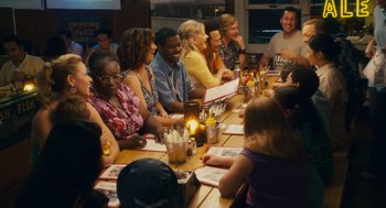 Movie still from “Grown Ups” (2010), directed by Dennis Dugan – A group of people sitting at a long table; Wide shot, High angle