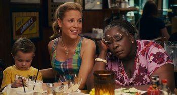 Movie still from “Grown Ups” (2010), directed by Dennis Dugan – Two women sitting at a table with a plate in front of them; Medium shot, Over the shoulder angle