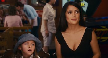 Movie still from “Grown Ups” (2010), directed by Dennis Dugan – A woman sitting next to a young girl in a hat; Close Up shot, Over the shoulder angle