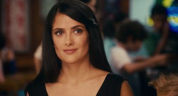 A woman with long black hair wearing a black dress