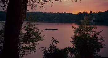 Movie still from “Grown Ups” (2010), directed by Dennis Dugan – A boat is floating on a lake at sunset; Extreme Wide shot, High angle