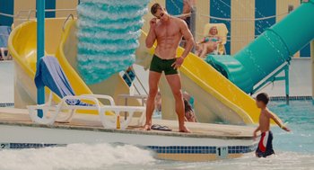 Movie still from “Grown Ups” (2010), directed by Dennis Dugan – A man standing next to a swimming pool; Wide shot, Over the shoulder angle