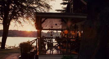 Movie still from “Grown Ups” (2010), directed by Dennis Dugan – A porch with a view of a lake at sunset; Extreme Wide shot, High angle