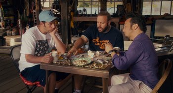 Movie still from “Grown Ups” (2010), directed by Dennis Dugan – A group of people sitting around a table eating food; Medium shot, High angle