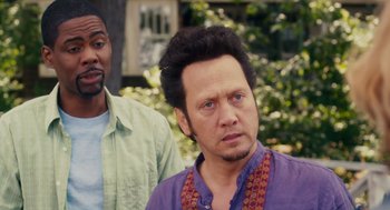 Movie still from “Grown Ups” (2010), directed by Dennis Dugan – Two men standing next to each other in front of trees; Close Up shot, Over the shoulder angle