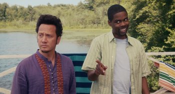 Movie still from “Grown Ups” (2010), directed by Dennis Dugan – Two men standing next to each other near a body of water; Medium shot, Over the shoulder angle