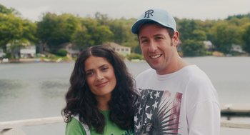 Movie still from “Grown Ups” (2010), directed by Dennis Dugan – A man and a woman standing next to each other near a body of water; Medium shot, High angle
