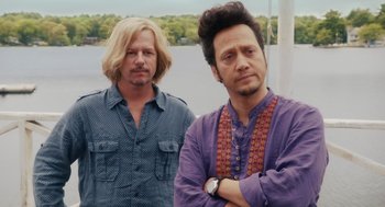 Movie still from “Grown Ups” (2010), directed by Dennis Dugan – Two men standing next to each other near a body of water; Medium shot, Over the shoulder angle