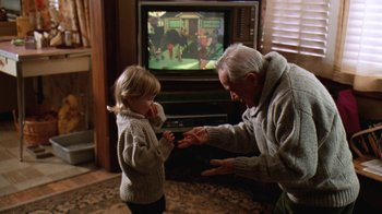 Movie still from “Grumpy Old Men” (1993), directed by Donald Petrie – An older man and a young boy playing a video game; Medium shot, Over the shoulder angle