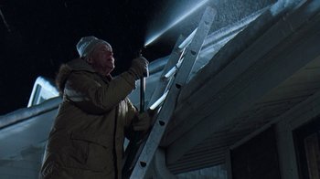 Movie still from “Grumpy Old Men” (1993), directed by Donald Petrie – A man in a brown jacket and a white hat holding a ladder; Medium shot, Low angle