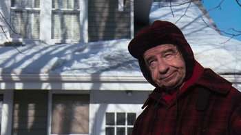 Movie still from “Grumpy Old Men” (1993), directed by Donald Petrie – An older man wearing a hood outside in the snow; Close Up shot, Over the shoulder angle