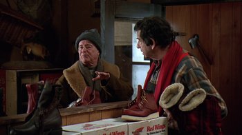 Movie still from “Grumpy Old Men” (1993), directed by Donald Petrie – A man in a red jacket is looking in the mirror; Medium shot, Over the shoulder angle