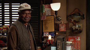 Movie still from “Grumpy Old Men” (1993), directed by Donald Petrie – A man standing in front of a counter in a store; Medium shot, Over the shoulder angle