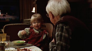 Movie still from “Grumpy Old Men” (1993), directed by Donald Petrie – An older man and a small child sitting at a dinner table; Medium shot, Over the shoulder angle