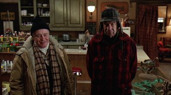 Movie still from “Grumpy Old Men” (1993), directed by Donald Petrie – Two men standing next to each other in a kitchen; Medium shot, High angle