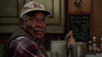 Movie still from “Grumpy Old Men” (1993), directed by Donald Petrie – An older man wearing a hat in a kitchen; Close Up shot, Low angle