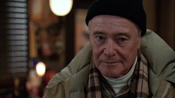 Movie still from “Grumpy Old Men” (1993), directed by Donald Petrie – An older man wearing a hat and a scarf; Close Up shot, Over the shoulder angle