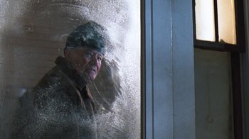 Movie still from “Grumpy Old Men” (1993), directed by Donald Petrie – An older man looking out of a window; Medium shot, Over the shoulder angle