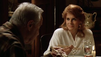 Movie still from “Grumpy Old Men” (1993), directed by Donald Petrie – An older man and a woman sitting at a table with chopsticks in their hands; Close Up shot, Over the shoulder angle