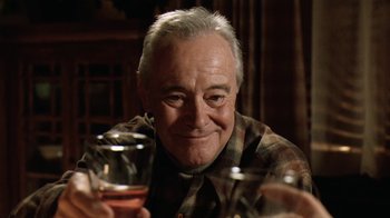 Movie still from “Grumpy Old Men” (1993), directed by Donald Petrie – An older man sitting in front of a glass of wine; Close Up shot, Low angle