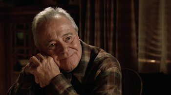 Movie still from “Grumpy Old Men” (1993), directed by Donald Petrie – An older man sitting in front of a curtain; Close Up shot, Low angle