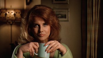 Movie still from “Grumpy Old Men” (1993), directed by Donald Petrie – A woman holding a coffee cup in her hands; Close Up shot, Over the shoulder angle