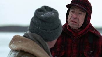 Movie still from “Grumpy Old Men” (1993), directed by Donald Petrie – A man wearing a plaid jacket and a hat; Close Up shot, Over the shoulder angle