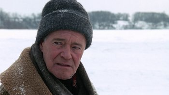 Movie still from “Grumpy Old Men” (1993), directed by Donald Petrie – An older man wearing a hat and a scarf in the snow; Close Up shot, Over the shoulder angle