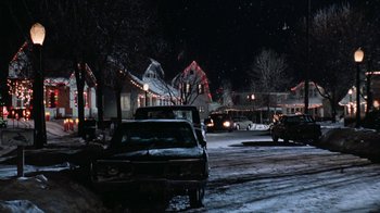 Movie still from “Grumpy Old Men” (1993), directed by Donald Petrie – Cars are parked on the side of the road at night; Extreme Wide shot, Low angle