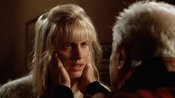 Movie still from “Grumpy Old Men” (1993), directed by Donald Petrie – A woman looking in the mirror while holding her hands to her face; Close Up shot, Over the shoulder angle