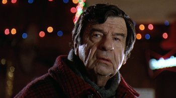 Movie still from “Grumpy Old Men” (1993), directed by Donald Petrie – An older man in a red jacket with lights in the background; Close Up shot, Low angle