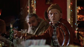 Movie still from “Grumpy Old Men” (1993), directed by Donald Petrie – Two older men sitting at a table with drinks; Medium shot, Low angle