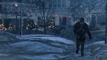 Movie still from “Grumpy Old Men” (1993), directed by Donald Petrie – A person walking in the snow near a house; Extreme Wide shot, High angle