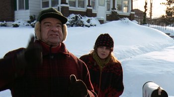Movie still from “Grumpy Old Men” (1993), directed by Donald Petrie – An older man and a young woman in the snow; Medium shot, Low angle
