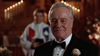 Movie still from “Grumpy Old Men” (1993), directed by Donald Petrie – An older man in a tuxedo with a flower in his lapel; Close Up shot, Low angle
