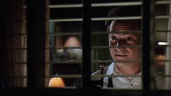 Movie still from “Grumpy Old Men” (1993), directed by Donald Petrie – A man looking out of a window through blinds; Close Up shot, Low angle