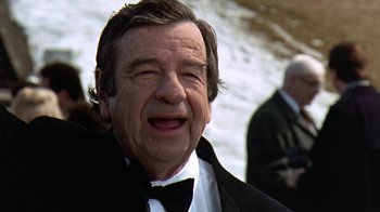 Movie still from “Grumpy Old Men” (1993), directed by Donald Petrie – An older man wearing a bow tie in front of a body of water; Close Up shot, Over the shoulder angle