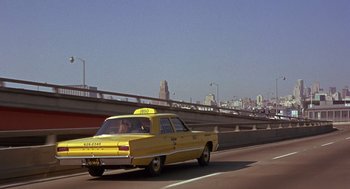 Movie still from “Guess Who's Coming to Dinner” (1967), directed by Stanley Kramer – A taxi cab driving down a highway with a bridge in the background; Wide shot, Low angle