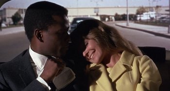 Movie still from “Guess Who's Coming to Dinner” (1967), directed by Stanley Kramer – A man and a woman smiling at each other; Close Up shot, Low angle