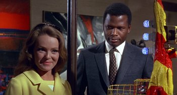 Movie still from “Guess Who's Coming to Dinner” (1967), directed by Stanley Kramer – A man and a woman standing next to each other; Medium shot, Low angle