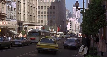 Movie still from “Guess Who's Coming to Dinner” (1967), directed by Stanley Kramer – A busy city street filled with lots of traffic; Extreme Wide shot, High angle